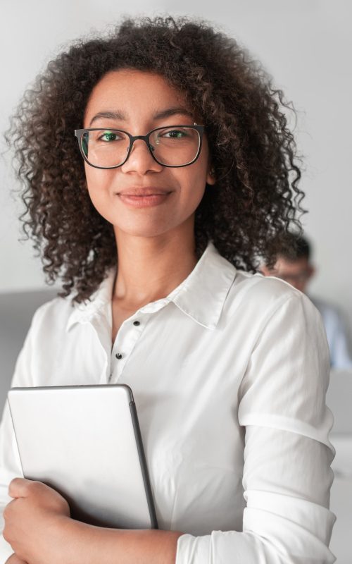 smiling-ethnic-female-recruiter-with-tablet-looking-at-camera-in-office.jpg